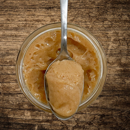 View of an open jar with a spoonful of product in front of it