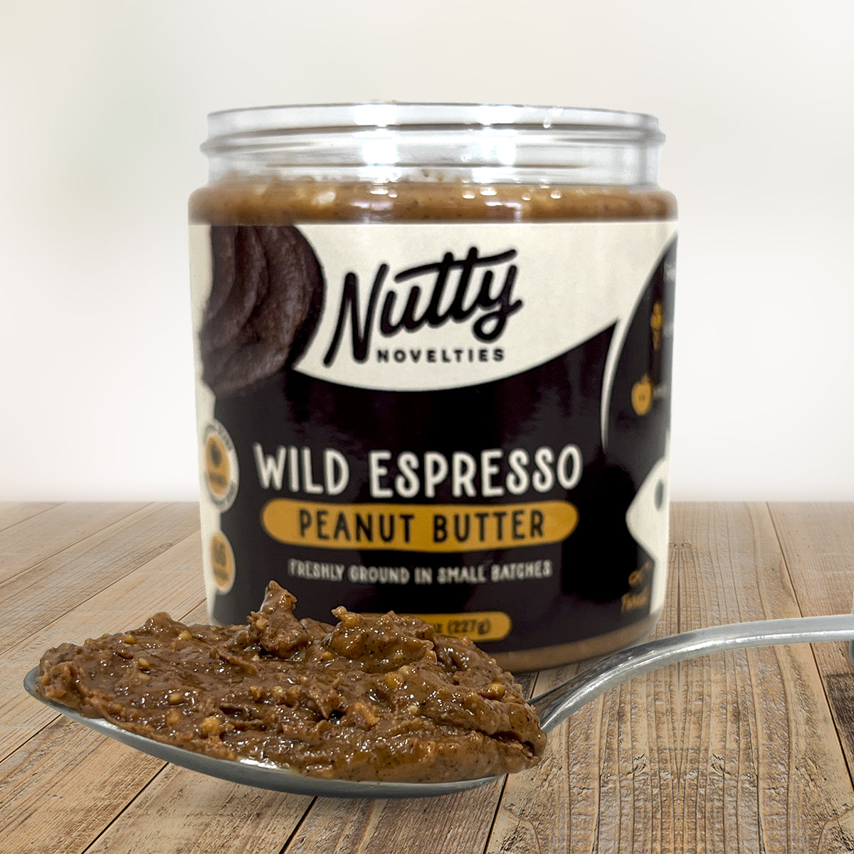 Wild Espresso Peanut Butter with spoon full of peanut butter in front of container