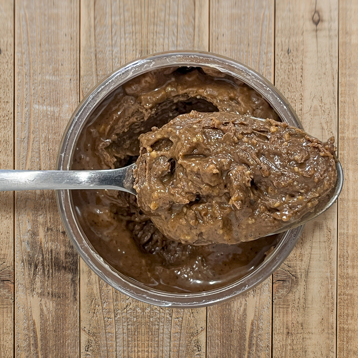 Wild Espresso Peanut Butter top view of open container with spoon full of peanut butter