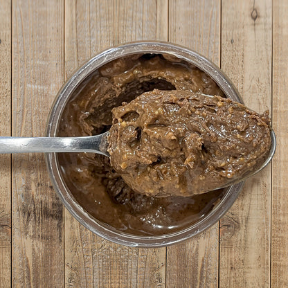 Wild Espresso Peanut Butter top view of open container with spoon full of peanut butter